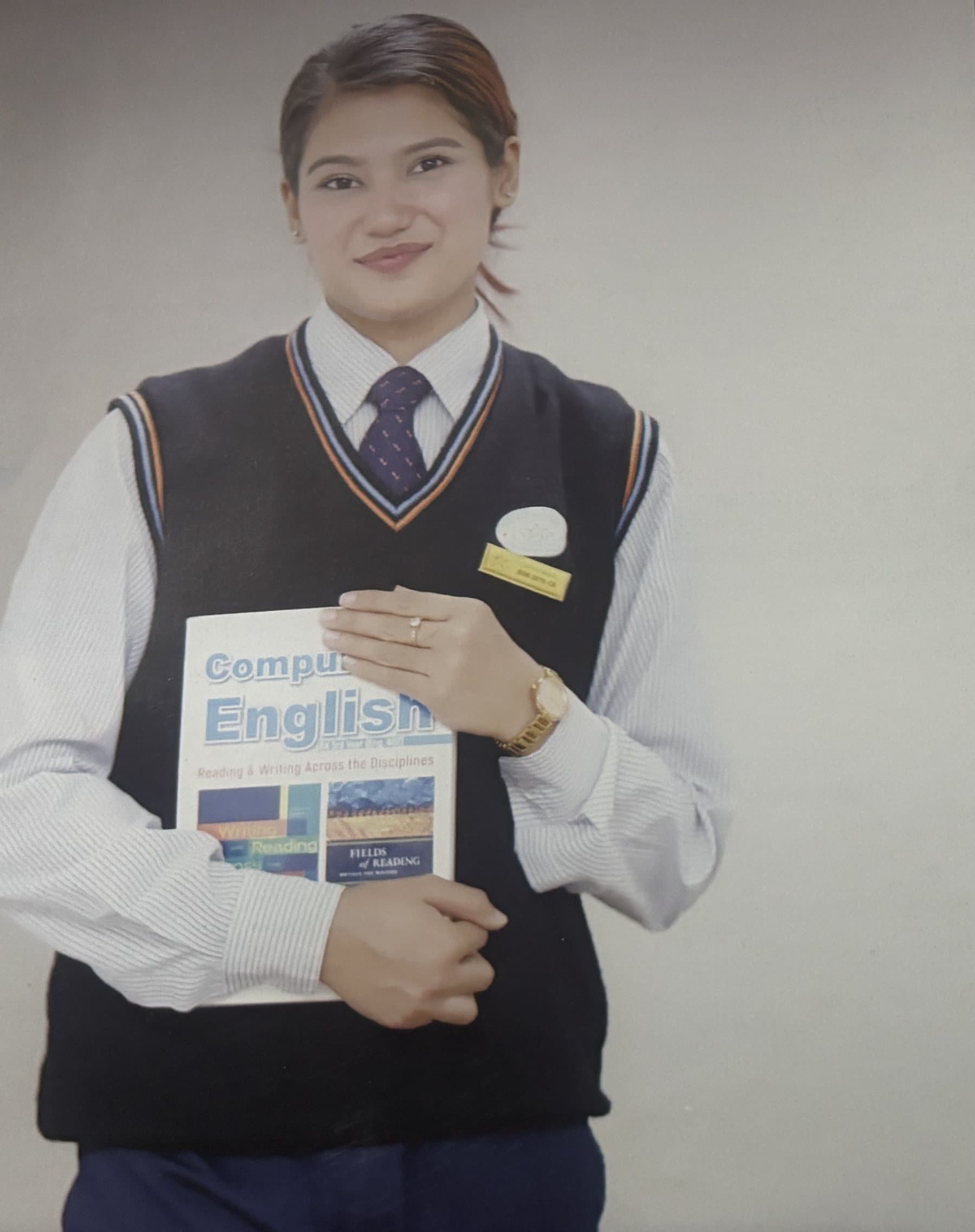 A BSW student holding a textbook in SWSC uniform