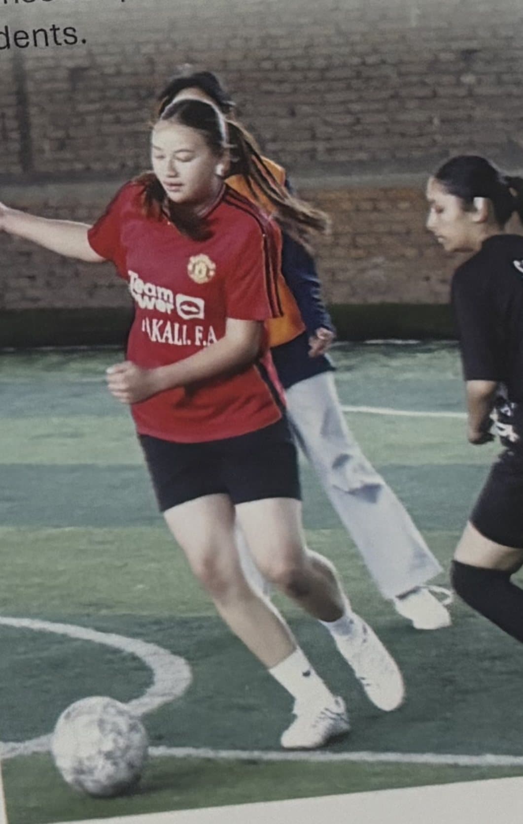 Two students competing in a football match